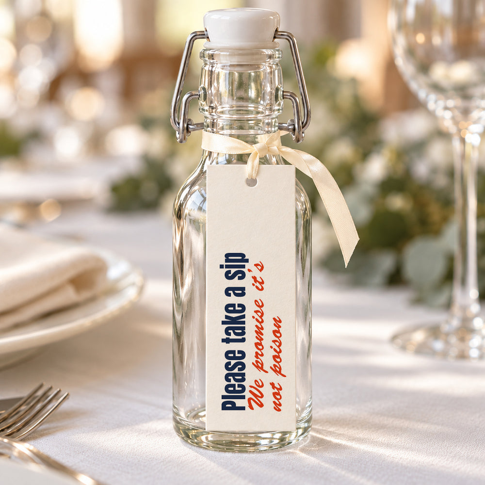 Illustrative wedding favour tag tied to a bottle