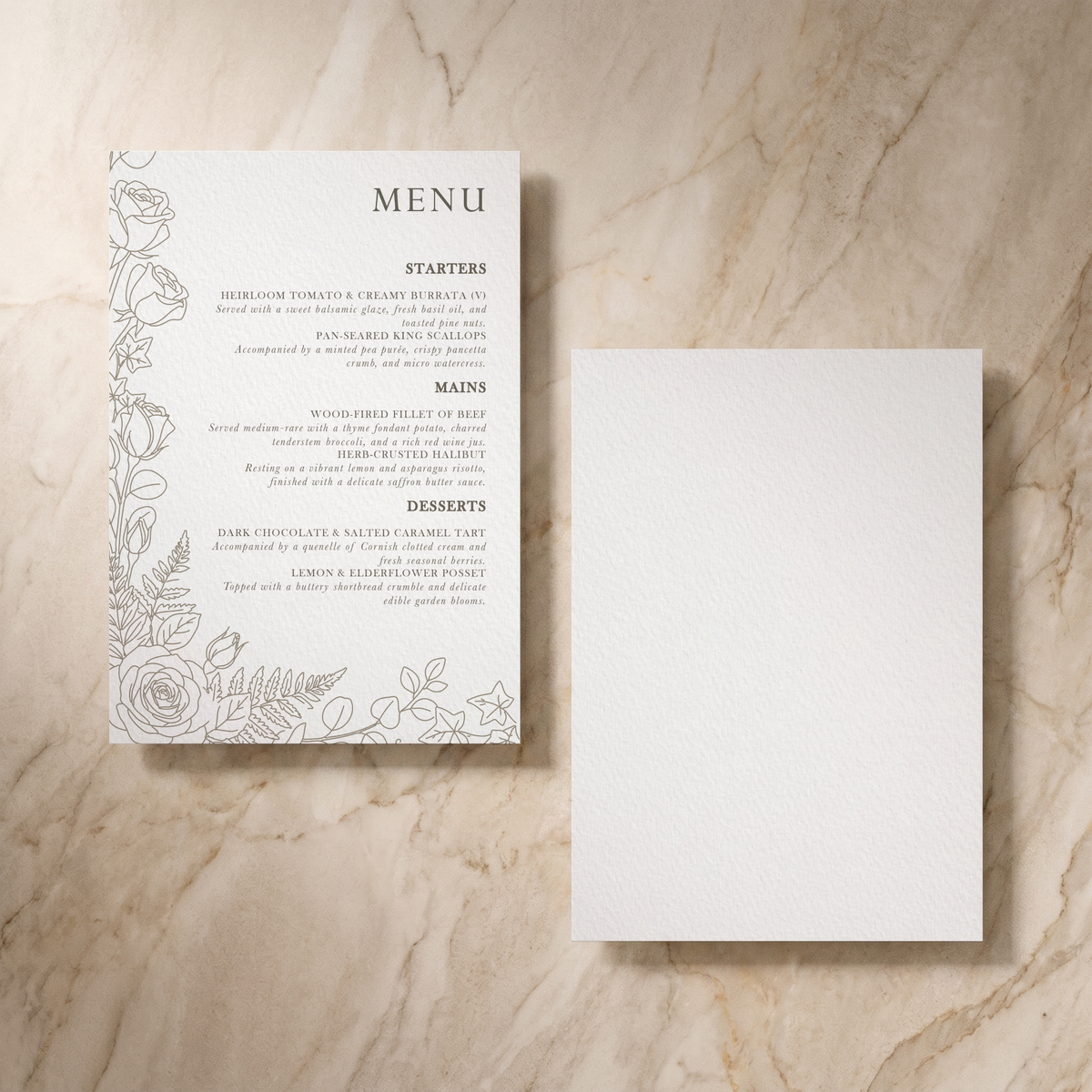 A printed menu card with elegant black text and delicate gray floral line art on white paper, placed beside an empty matching card on a light beige marble surface.