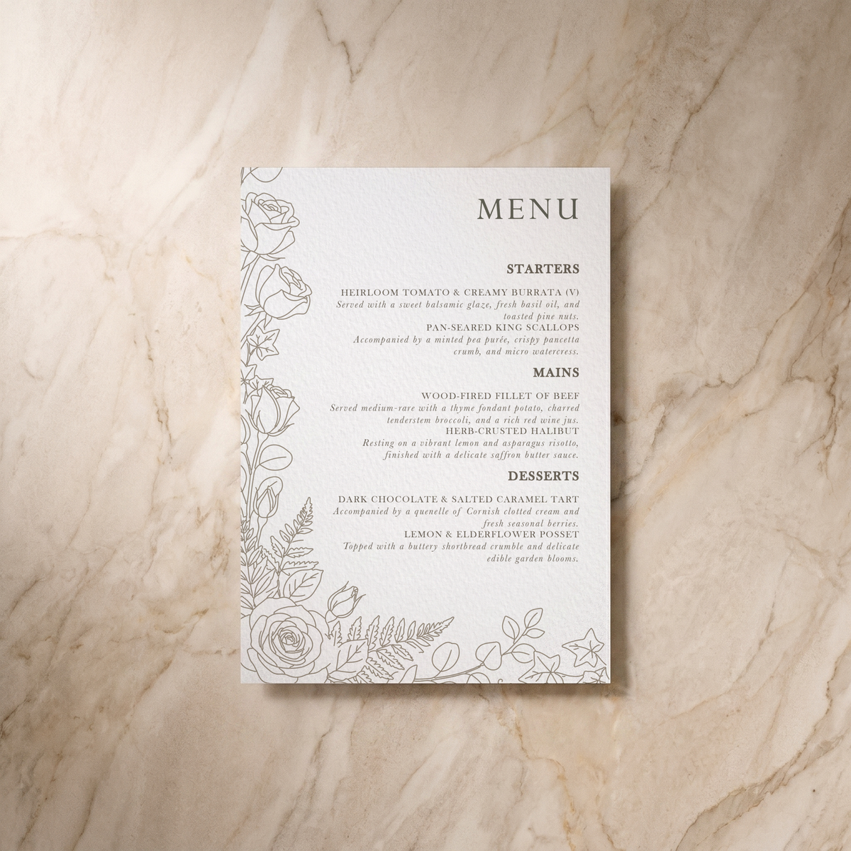 A rectangular printed menu card with elegant black typography and delicate floral line art along the left side, placed on a light beige marble surface.