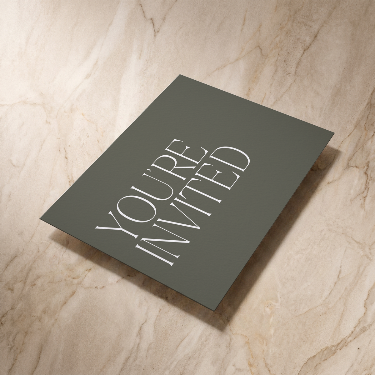 Typeface wedding invitation in forest green, reverse shown at an angle, designed and printed in Suffolk