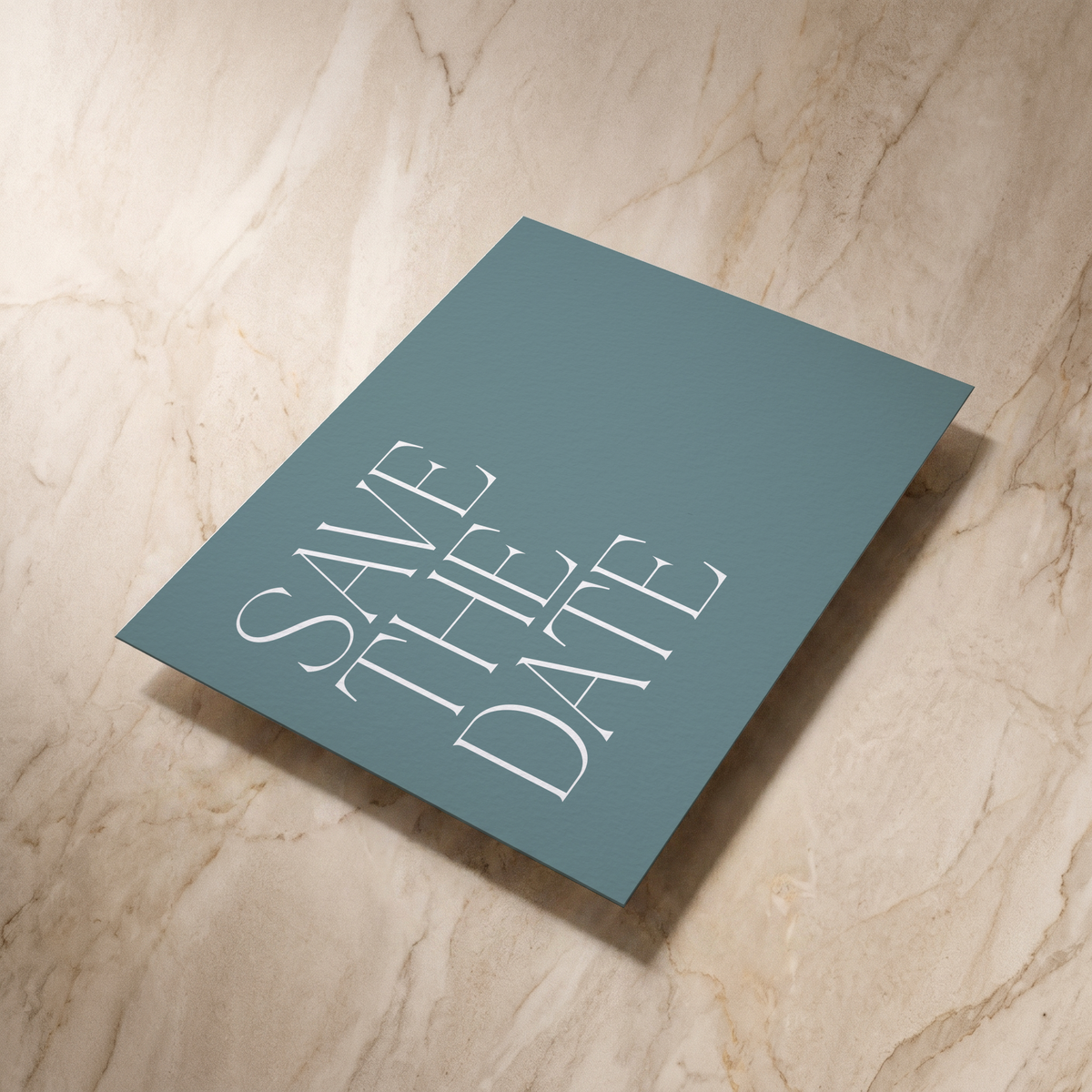 Typeface save the date card in powder blue, reverse shown at an angle, designed and printed in Suffolk