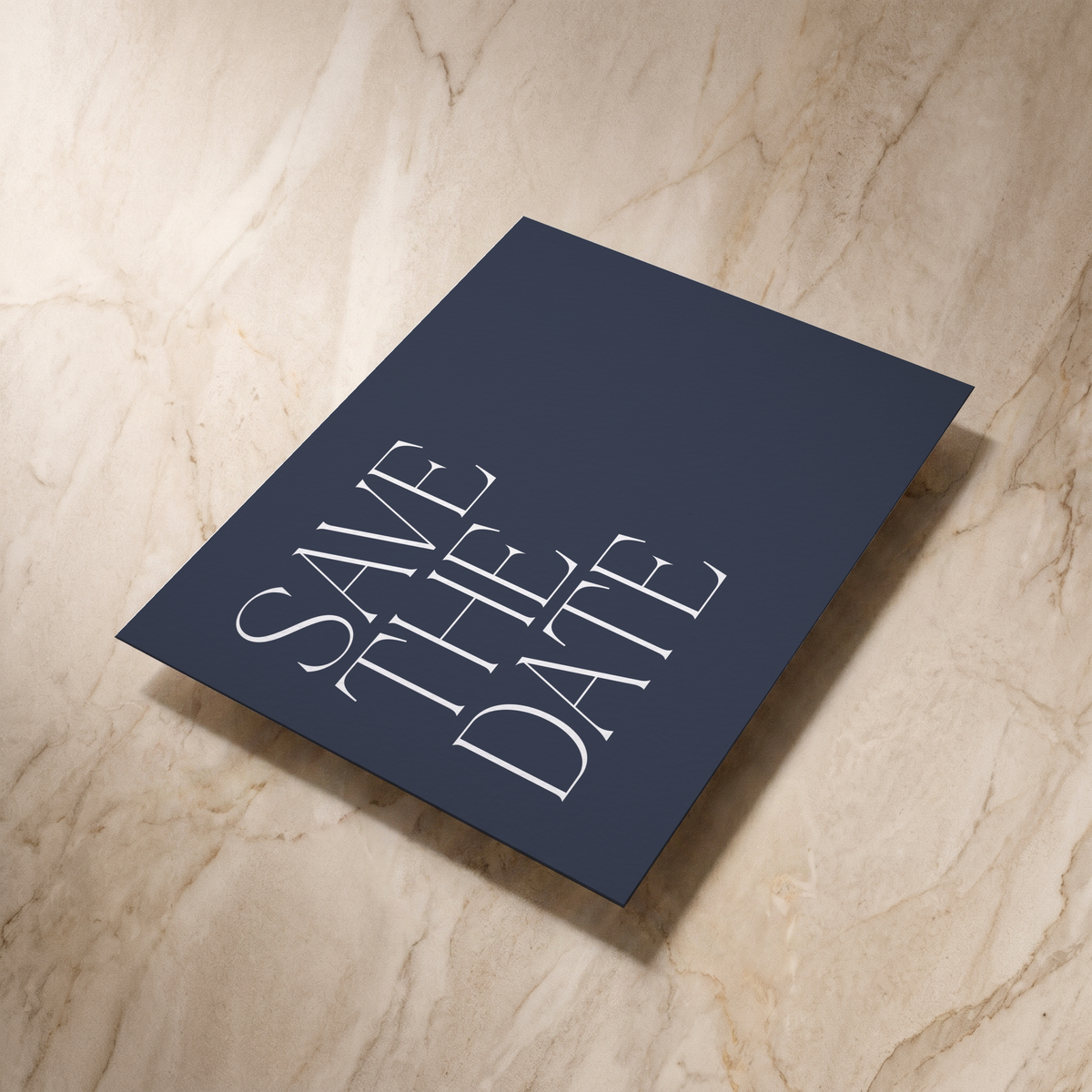 Typeface save the date card in navy, reverse shown at an angle, designed and printed in Suffolk