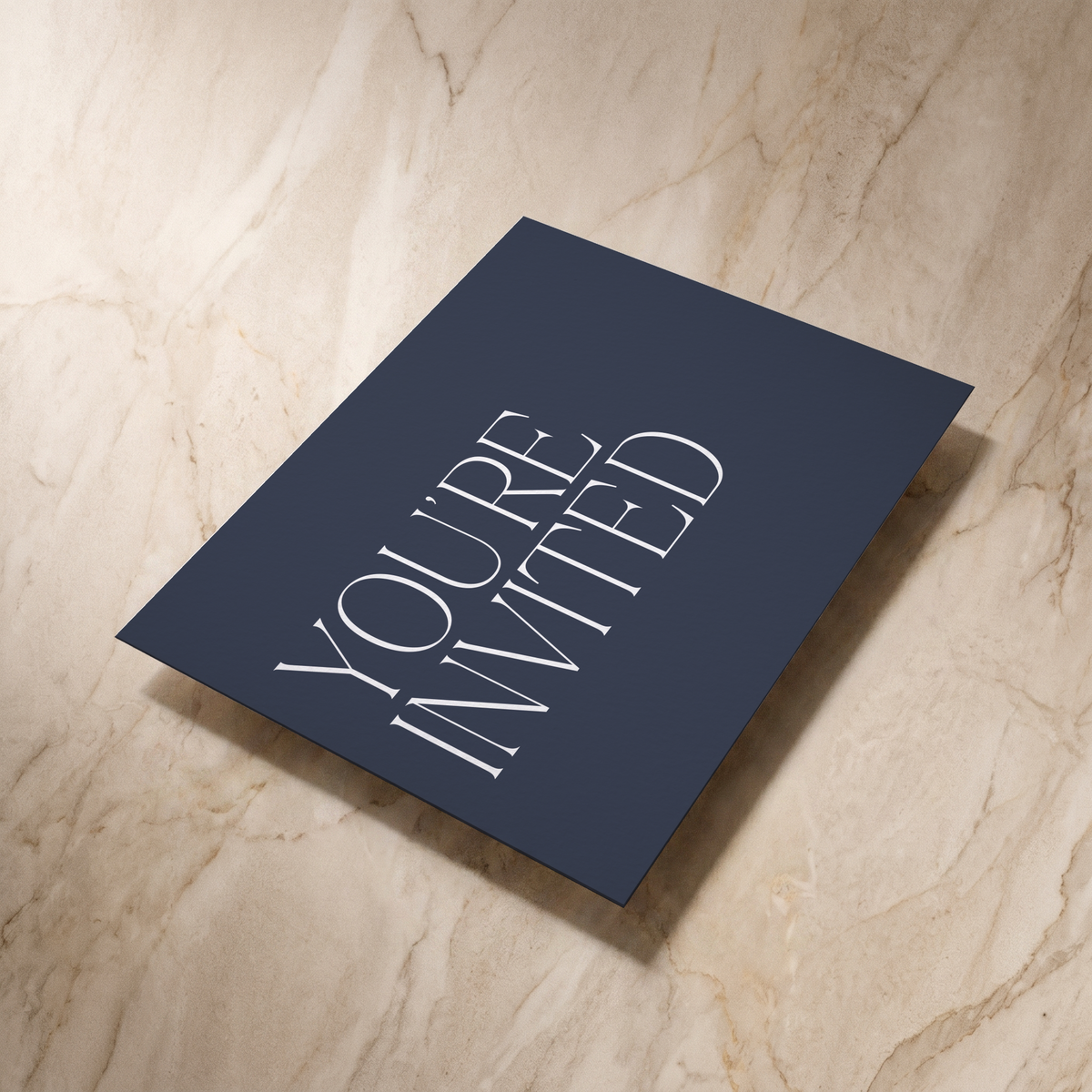 Typeface wedding invitation in navy, reverse shown at an angle, designed and printed in Suffolk