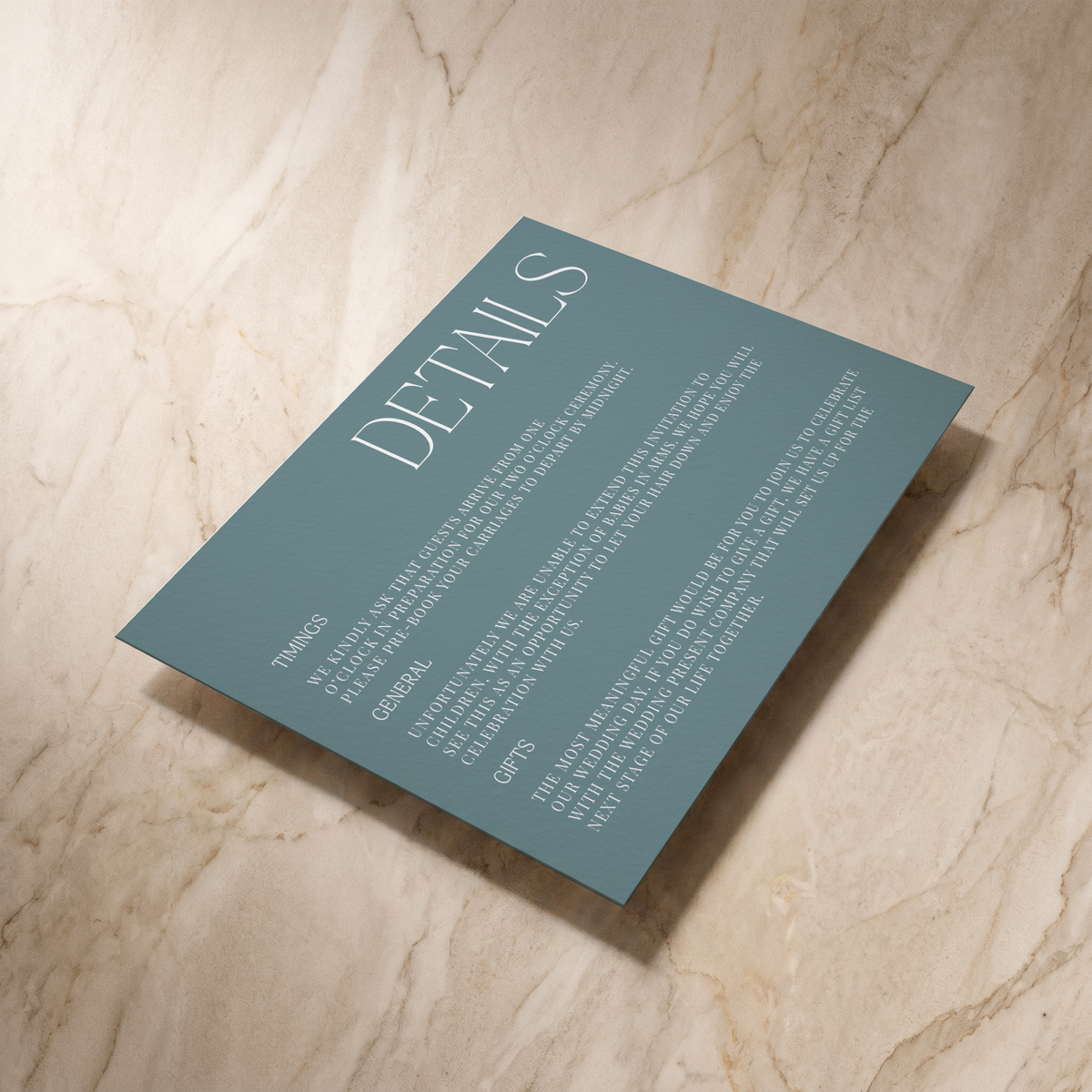 Typeface wedding details card in powder blue, shown at an angle, designed and printed in Suffolk
