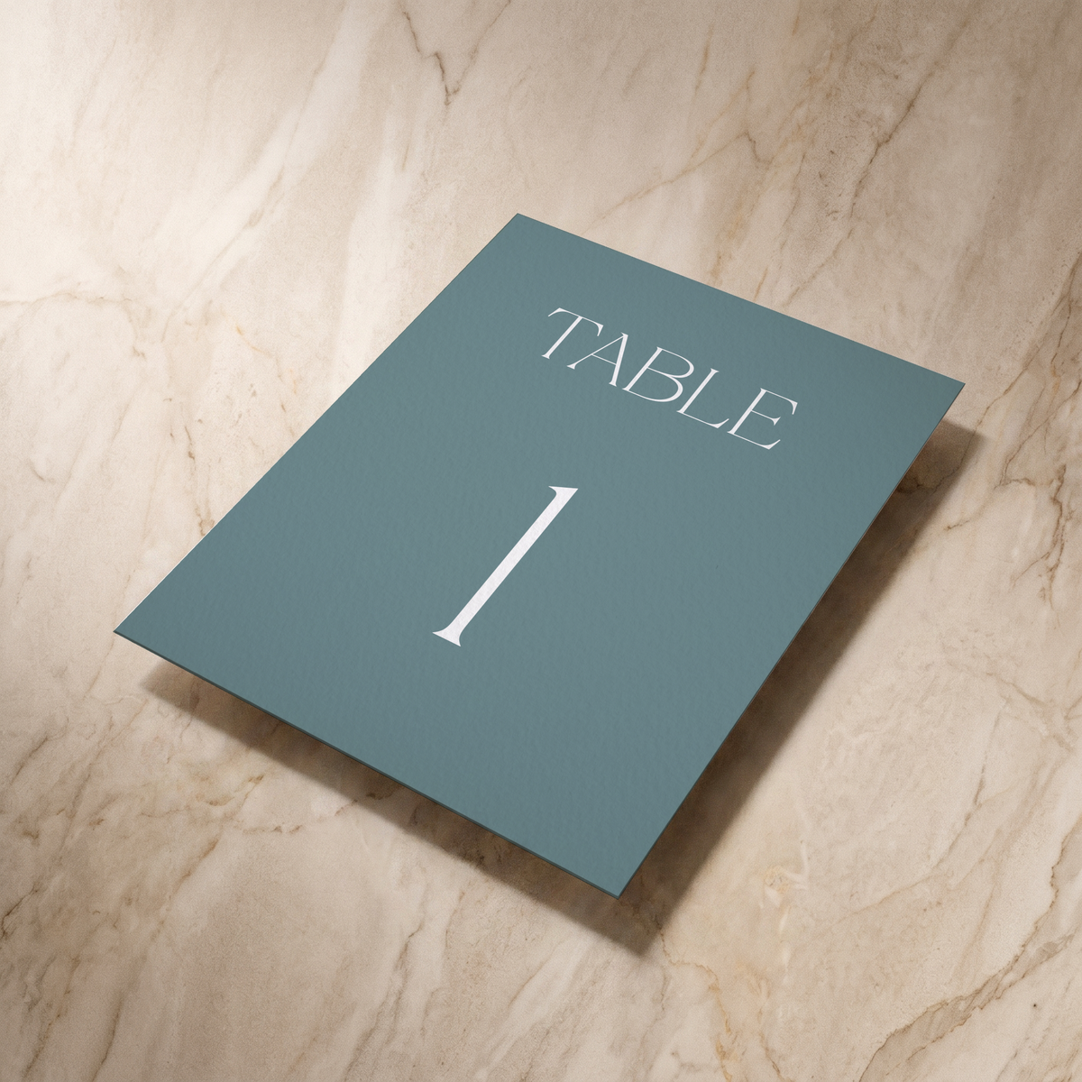 Typeface table number card in powder blue, shown at an angle, designed and printed in Suffolk
