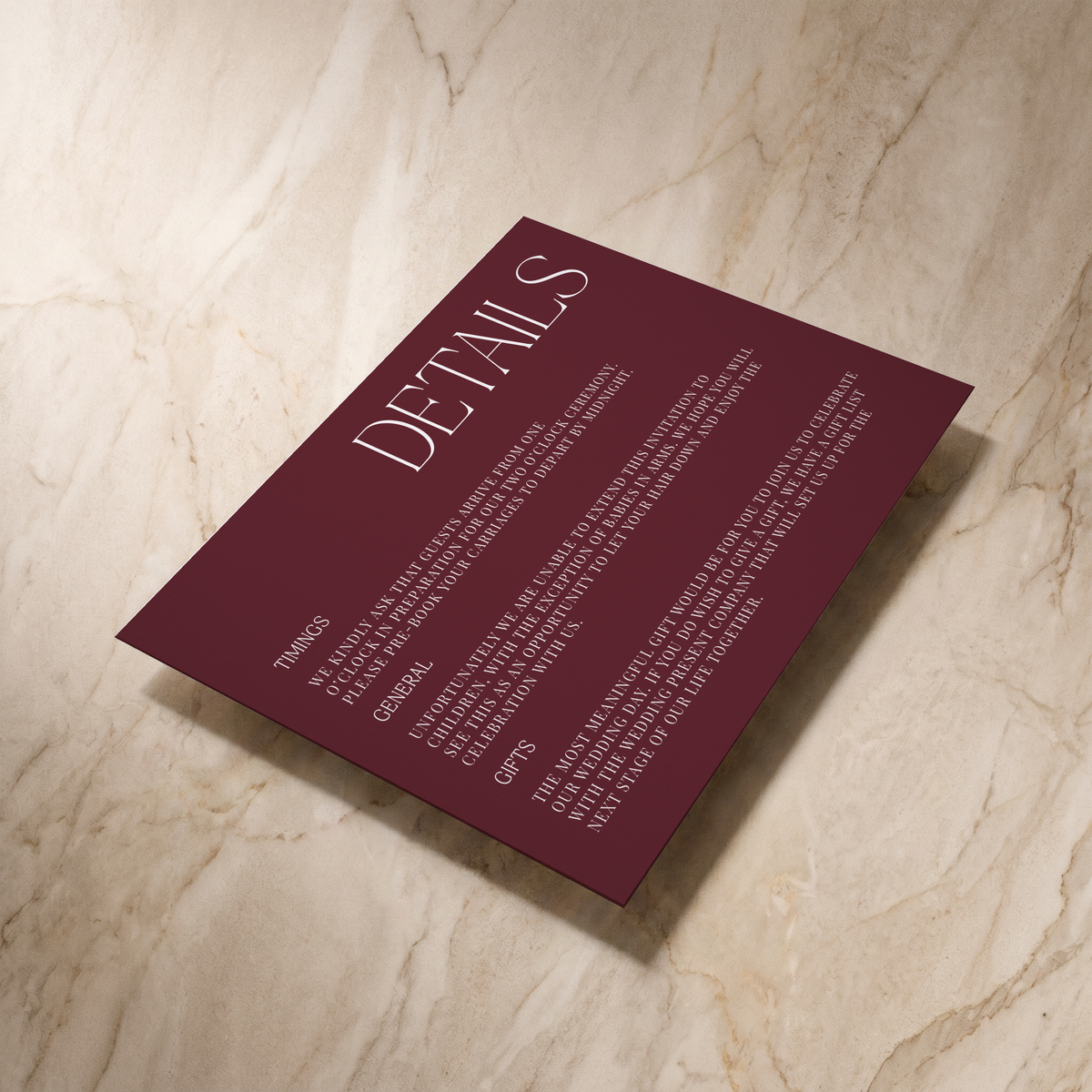 Typeface wedding details card in maroon, shown at an angle, designed and printed in Suffolk