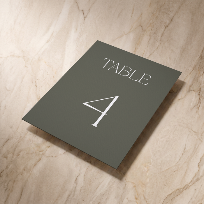 Typeface table number card in forest green, shown at an angle, designed and printed in Suffolk