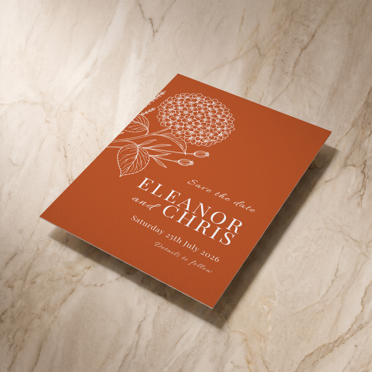 Hydrangea save the date card, shown at an angle, designed and printed in Suffolk